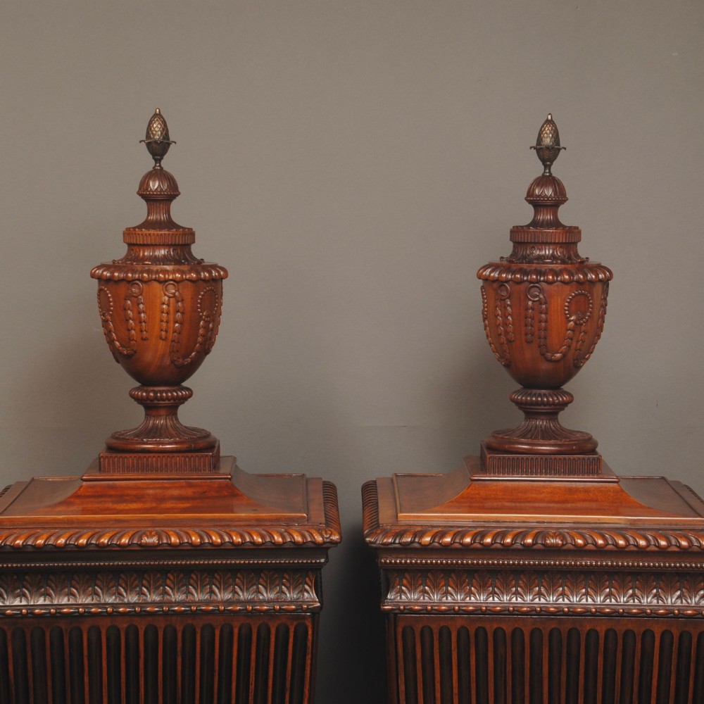 A pair of 18th-century mahogany dining pedestals featuring fluted square bodies, moulded bases, and detailed carved urn finials. View III