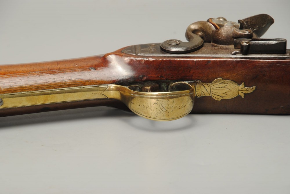 A Georgian flintlock blunderbuss featuring a flared brass barrel, steel lock plate, and polished walnut wooden stock. View III