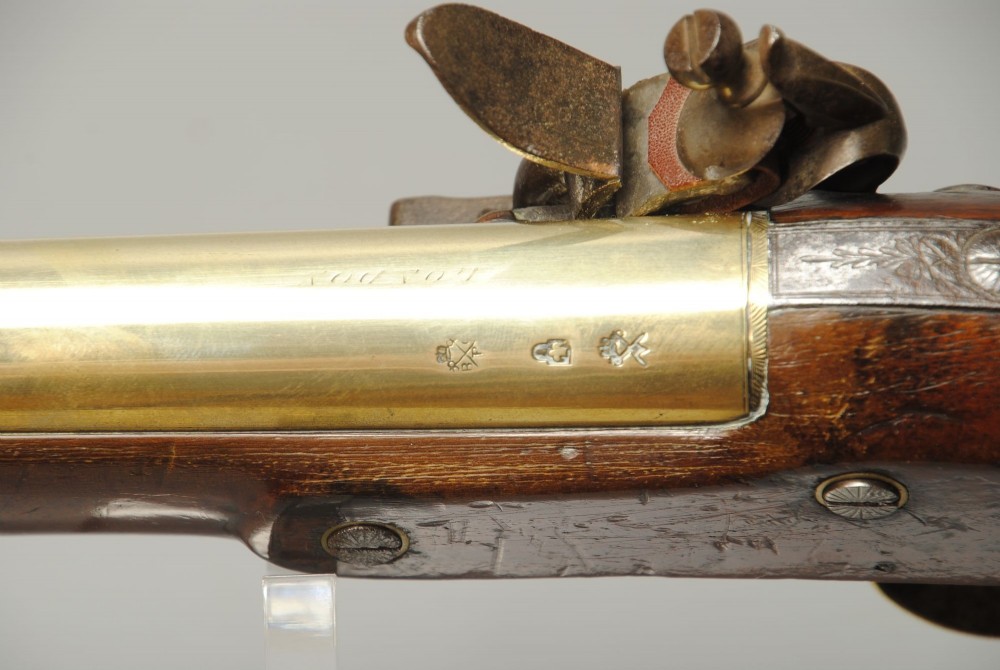 A Georgian flintlock blunderbuss featuring a flared brass barrel, steel lock plate, and polished walnut wooden stock. View IV