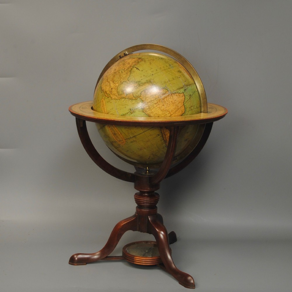 An early nineteenth-century terrestrial table globe supported by a turned mahogany tripod stand with a brass meridian ring and an integrated base compass. View II