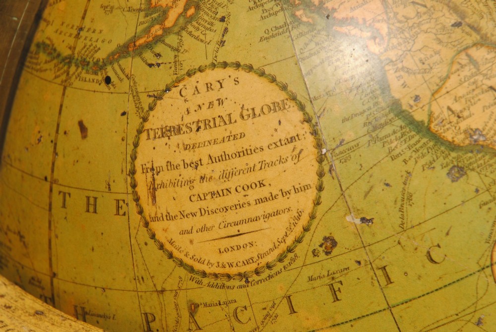 An early nineteenth-century terrestrial table globe supported by a turned mahogany tripod stand with a brass meridian ring and an integrated base compass. View III