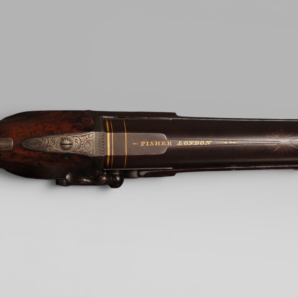 An antique six bore percussion fowling piece with an extended steel barrel and dark walnut stock. View II