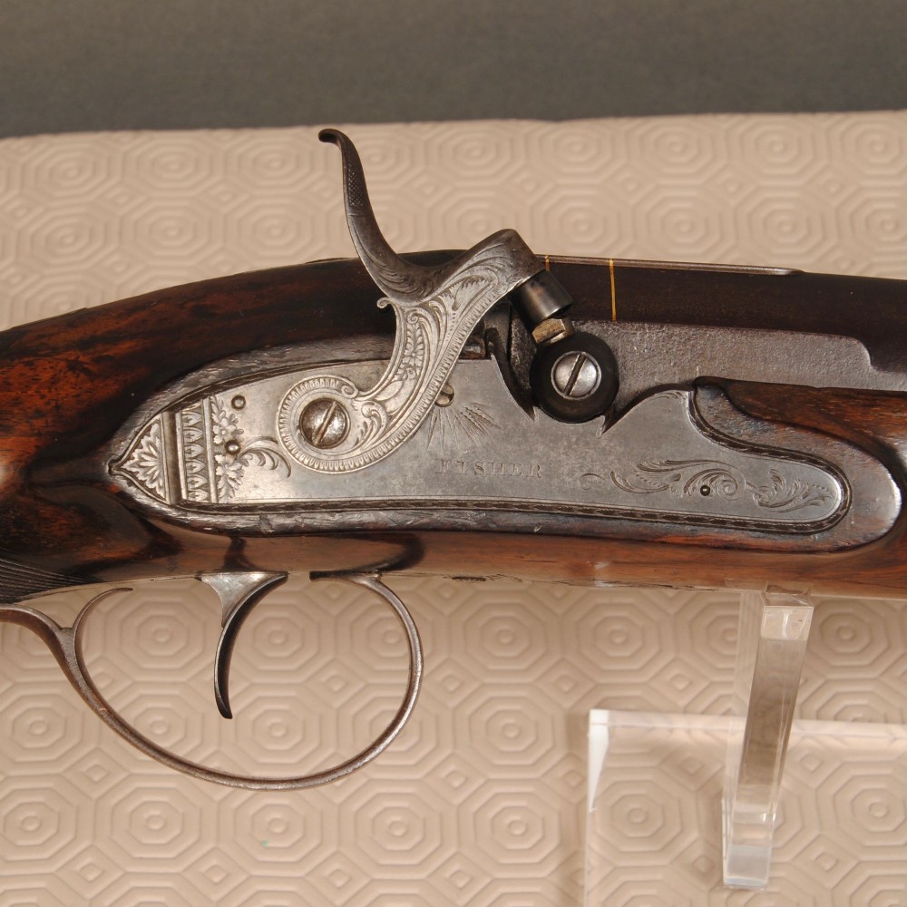An antique six bore percussion fowling piece with an extended steel barrel and dark walnut stock. View III