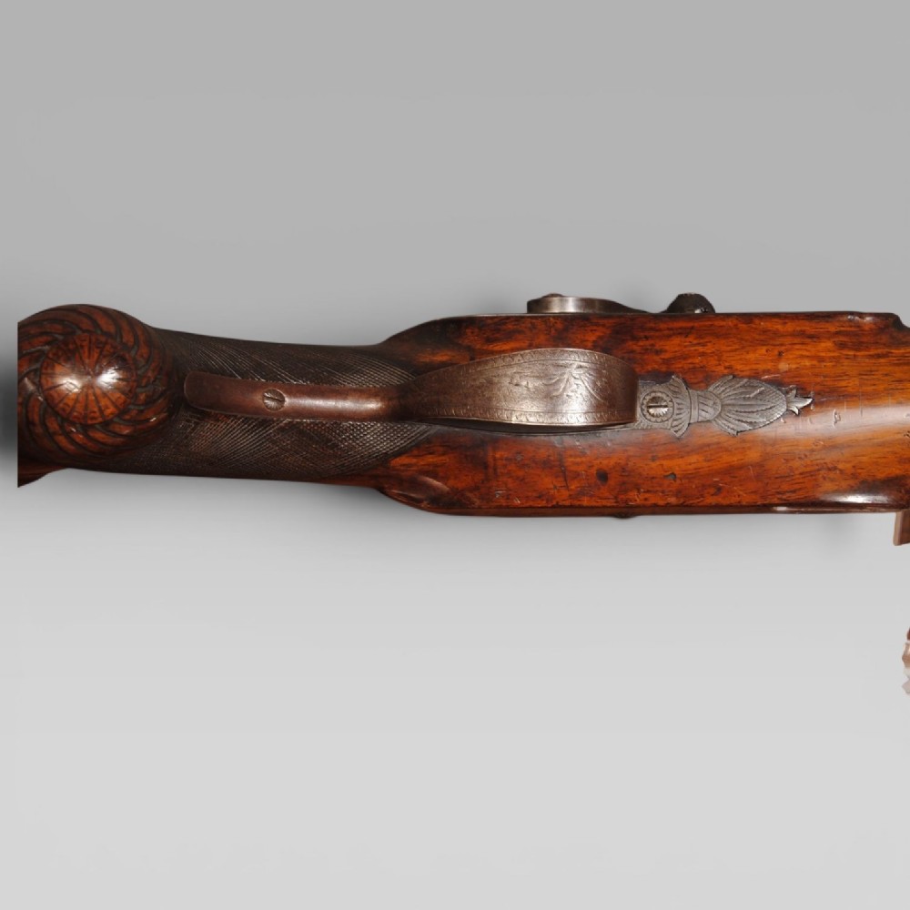 An antique six bore percussion fowling piece with an extended steel barrel and dark walnut stock. View IV