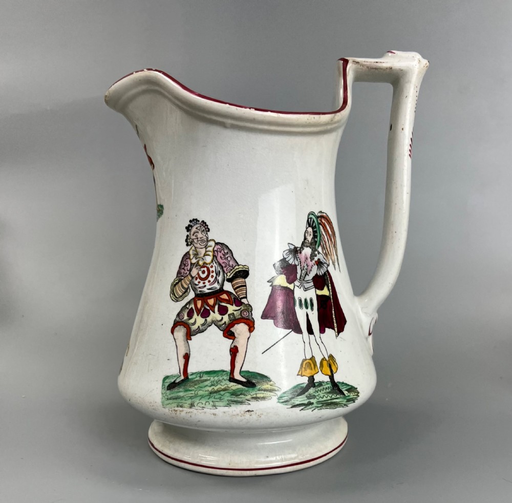 A cream earthenware ceramic jug decorated with hand-coloured transfer prints of circus performers and clowns with a red painted rim. View II