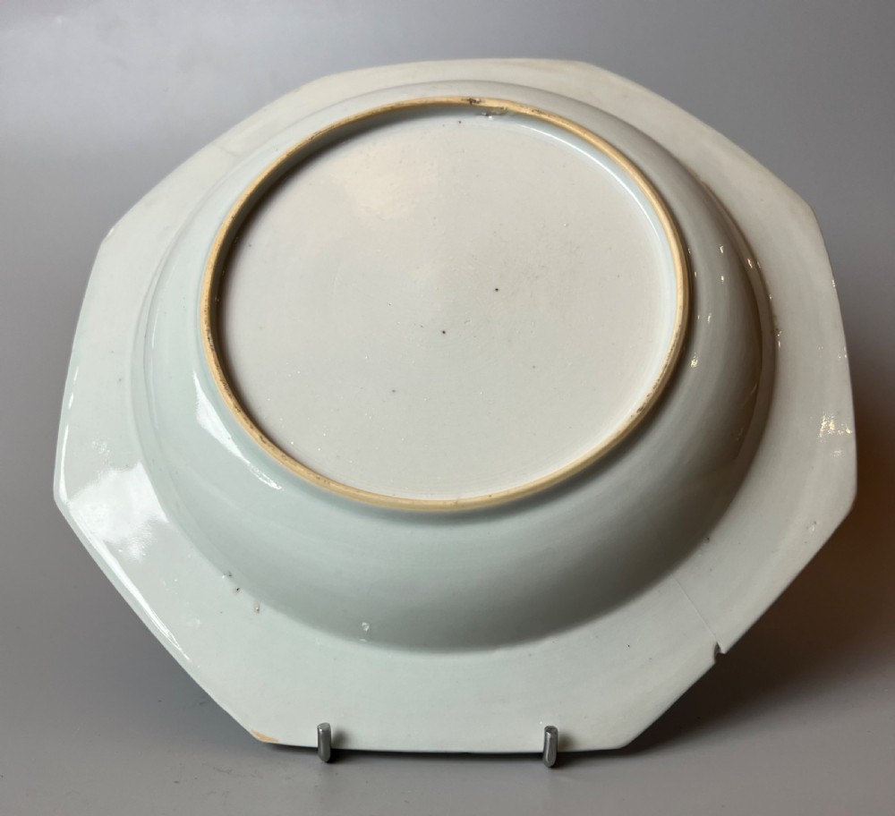 A late 18th-century Chinese export porcelain plate featuring hand-painted cobalt blue river landscapes, pagodas, and a patterned border on a white background. View IV