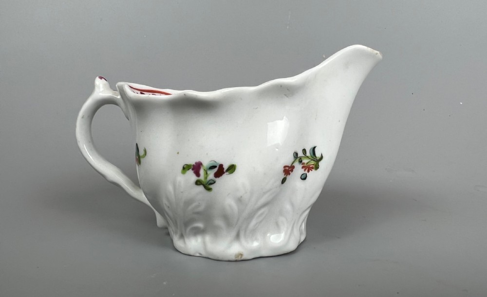 An 18th-century white soft-paste porcelain low Chelsea ewer decorated with hand-painted floral sprigs and leaf moulding. View III