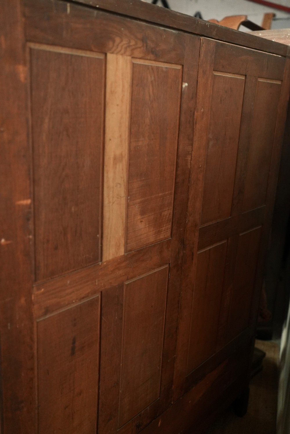 An Edwardian mahogany wardrobe featuring a central full-length mirror door flanked by inlaid timber doors over two lower drawers. View IX