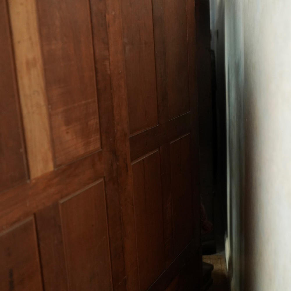 An Edwardian mahogany wardrobe featuring a central full-length mirror door flanked by inlaid timber doors over two lower drawers. View X