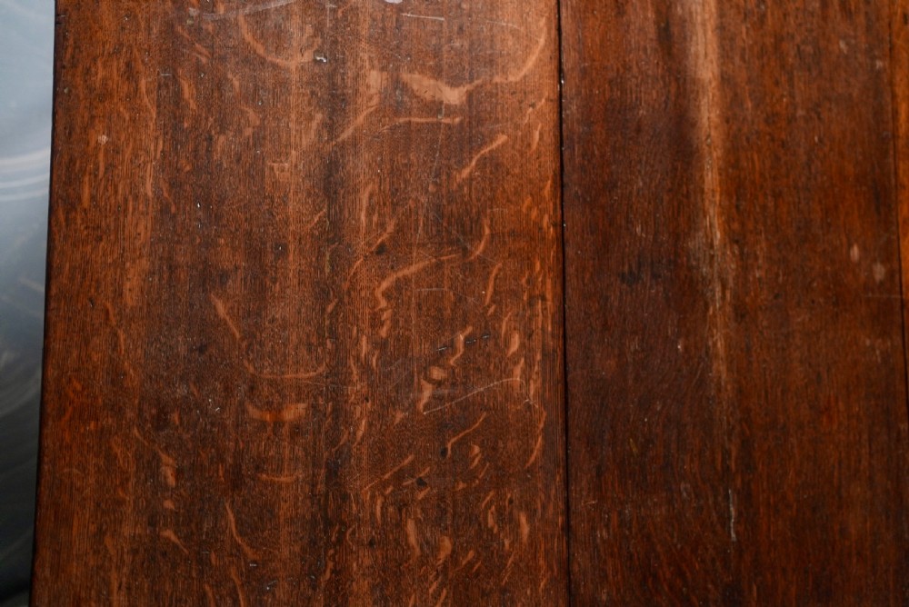 An 18th-century oak gateleg dining table featuring drop-leaf flaps supported by swinging legs terminating in pad feet. View VI