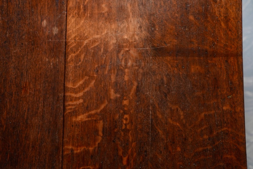An 18th-century oak gateleg dining table featuring drop-leaf flaps supported by swinging legs terminating in pad feet. View IX
