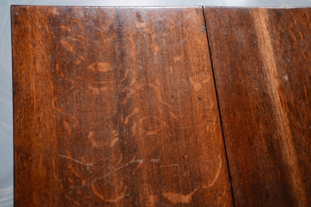 An 18th-century oak gateleg dining table featuring drop-leaf flaps supported by swinging legs terminating in pad feet. View XII