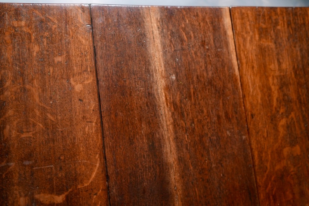An 18th-century oak gateleg dining table featuring drop-leaf flaps supported by swinging legs terminating in pad feet. View XIII