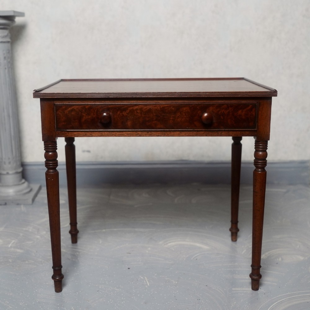 A 19th-century mahogany writing table featuring a single long drawer with turned wooden knobs and slender turned legs. View III