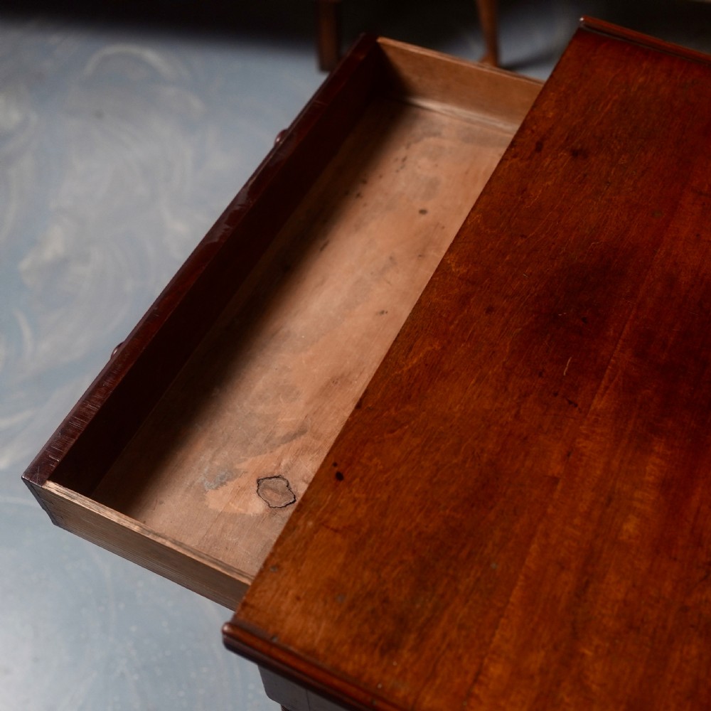 A 19th-century mahogany writing table featuring a single long drawer with turned wooden knobs and slender turned legs. View IV