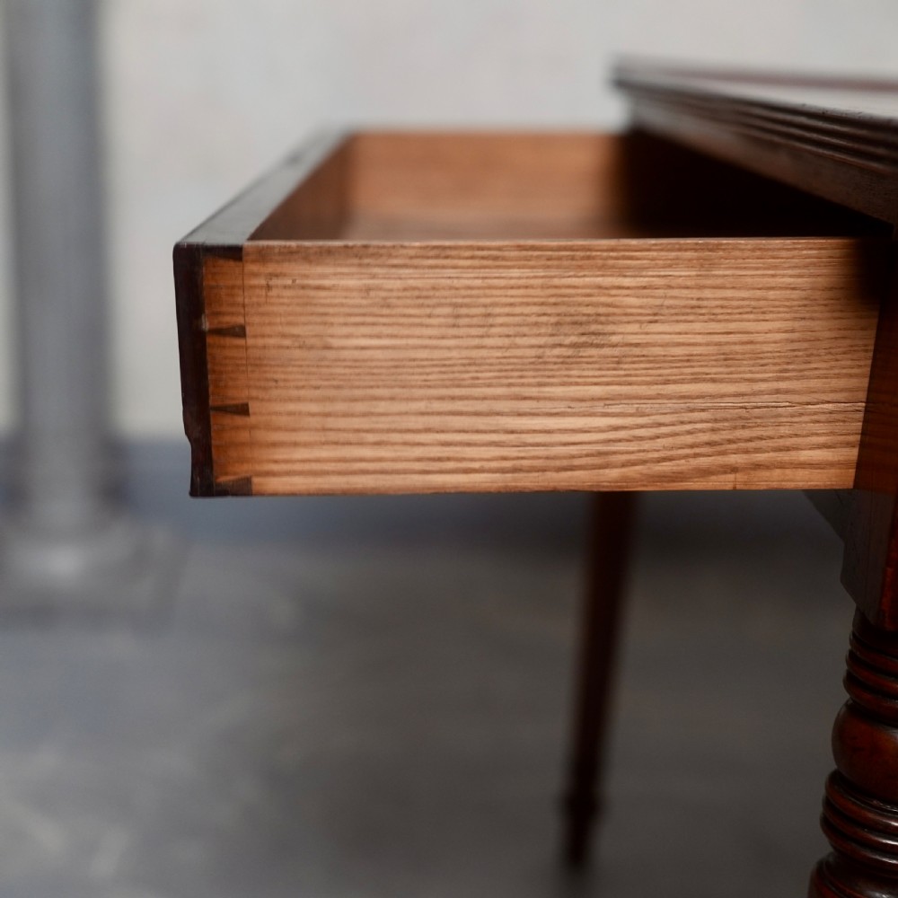 A 19th-century mahogany writing table featuring a single long drawer with turned wooden knobs and slender turned legs. View VI