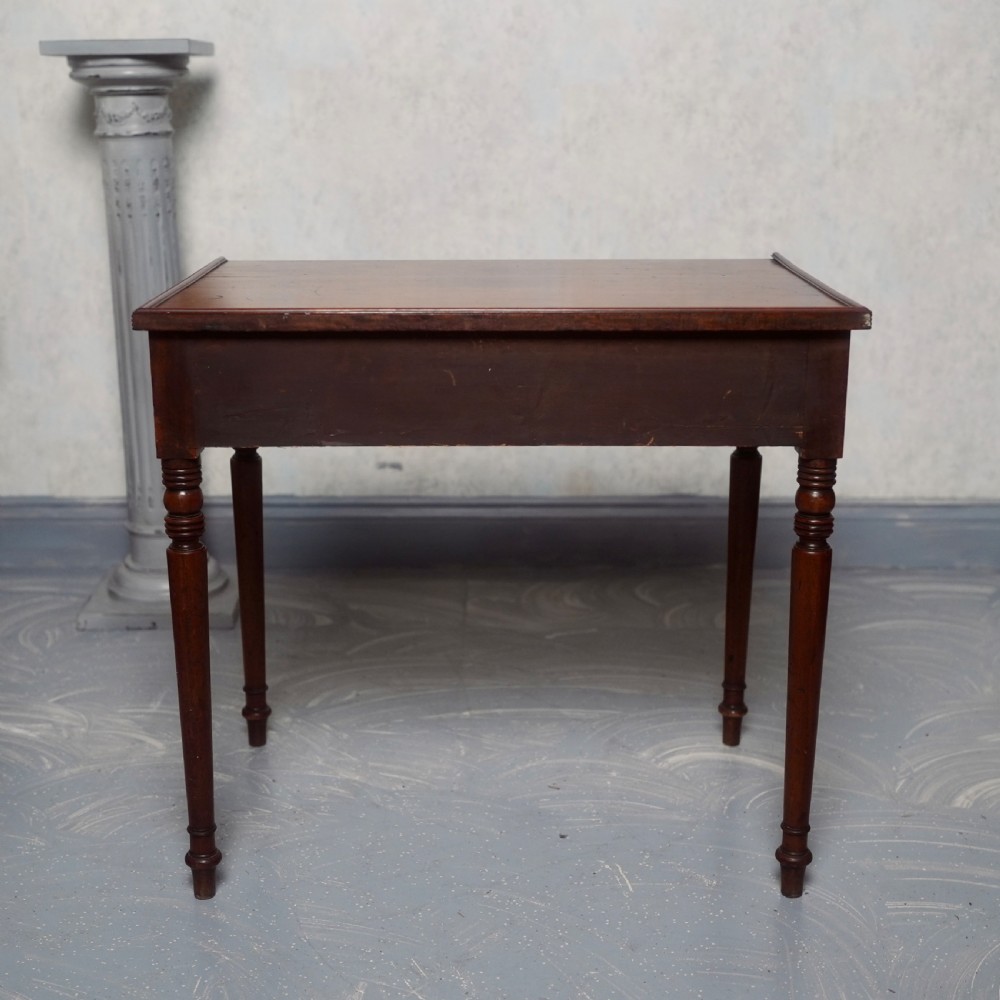 A 19th-century mahogany writing table featuring a single long drawer with turned wooden knobs and slender turned legs. View VII
