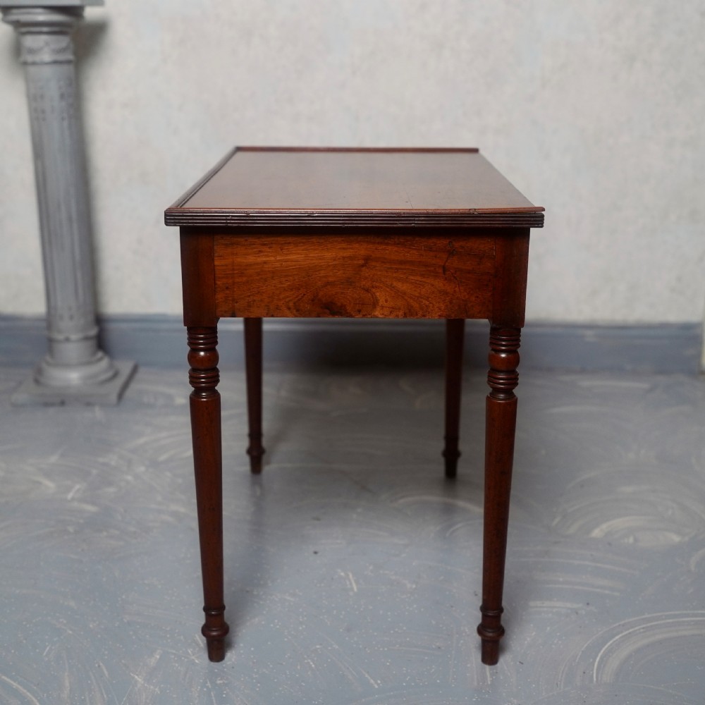 A 19th-century mahogany writing table featuring a single long drawer with turned wooden knobs and slender turned legs. View VIII