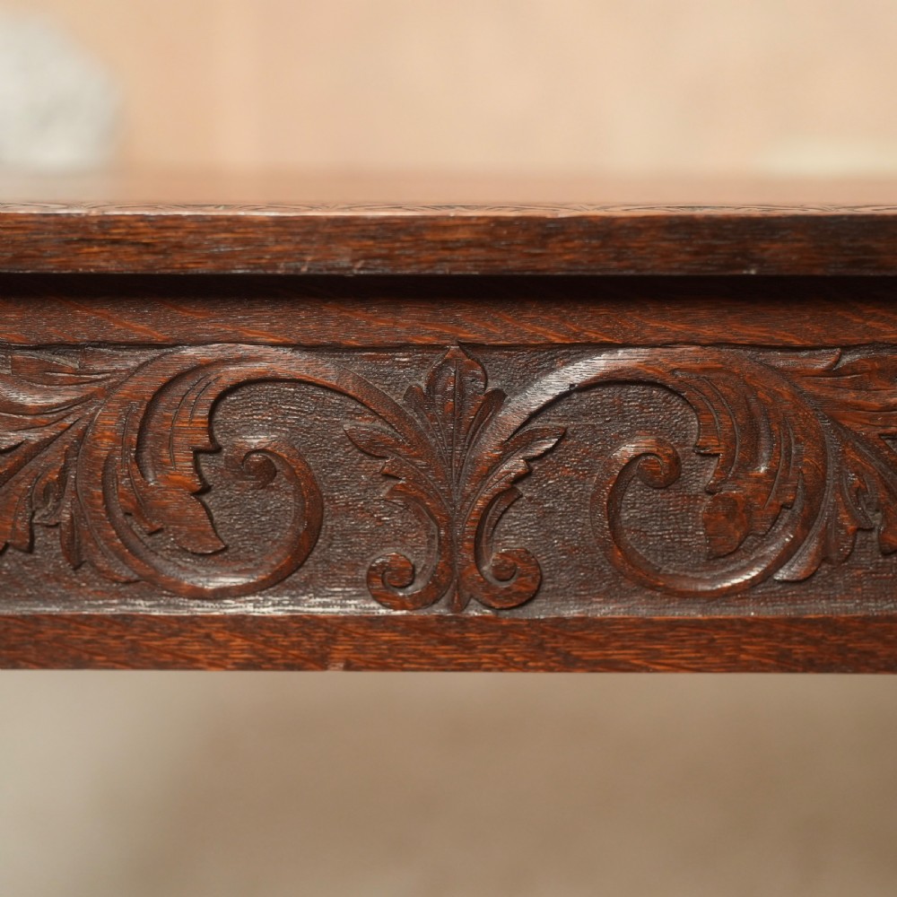 An 18th-century Irish dark oak writing table featuring a hand-carved floral apron and slender cabriole legs. View III