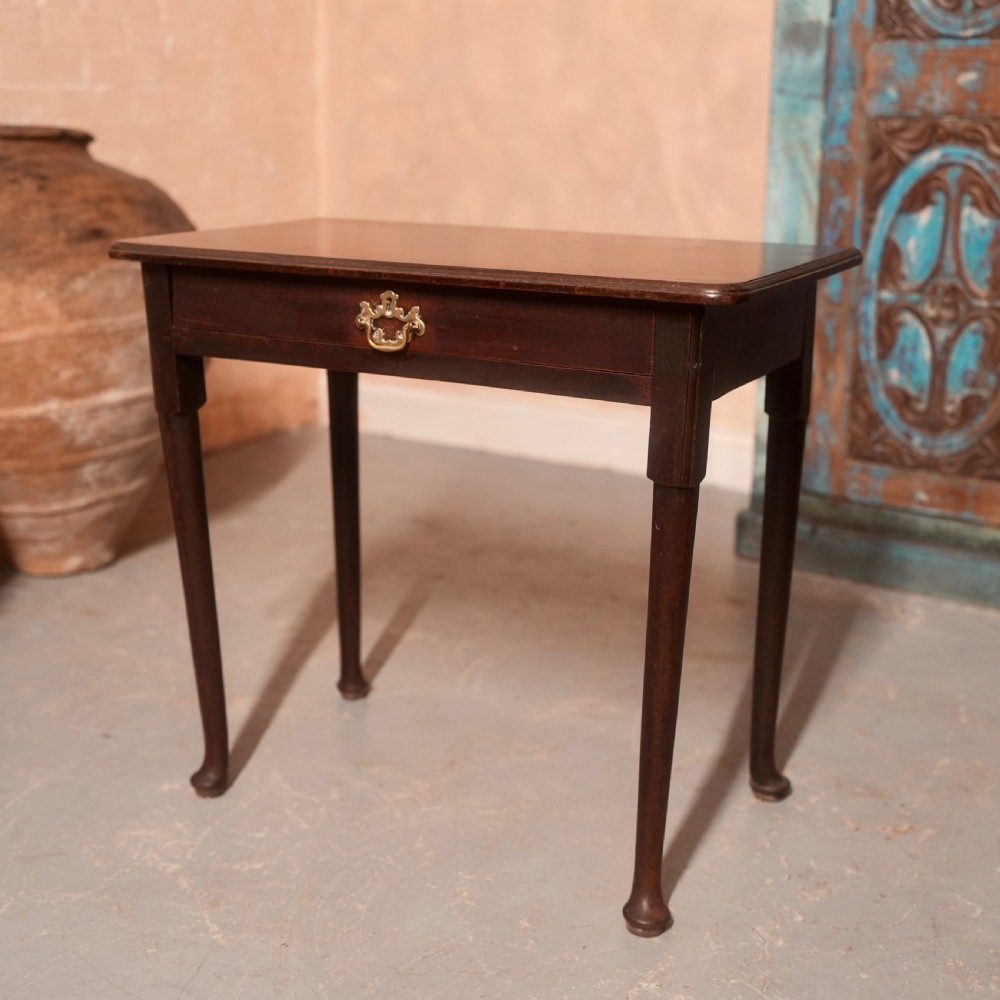 An 18th-century dark mahogany writing table featuring a single drawer with a brass handle plate and slender legs. View II