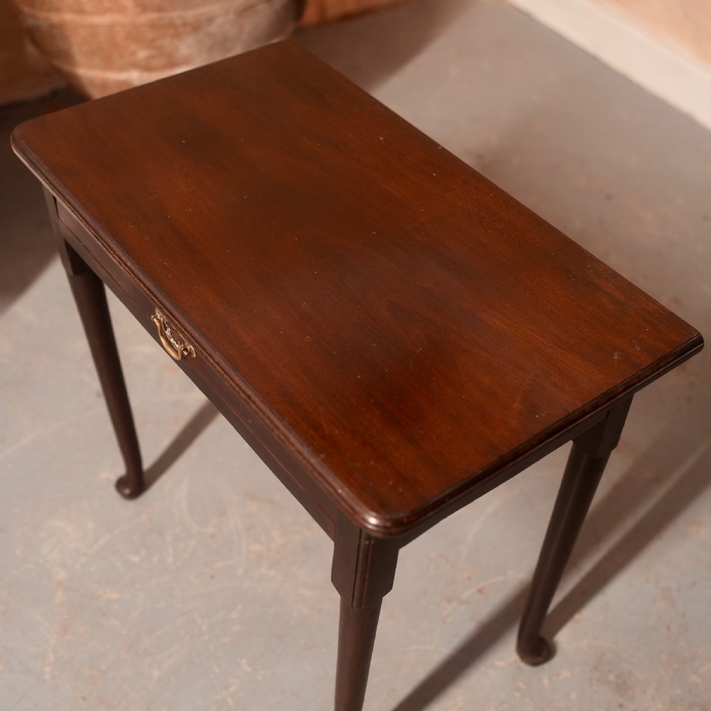 An 18th-century dark mahogany writing table featuring a single drawer with a brass handle plate and slender legs. View III