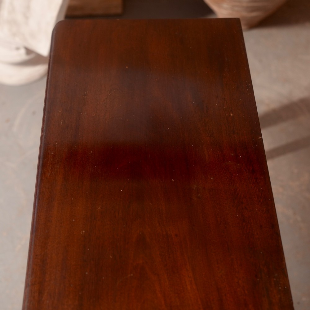 An 18th-century dark mahogany writing table featuring a single drawer with a brass handle plate and slender legs. View V