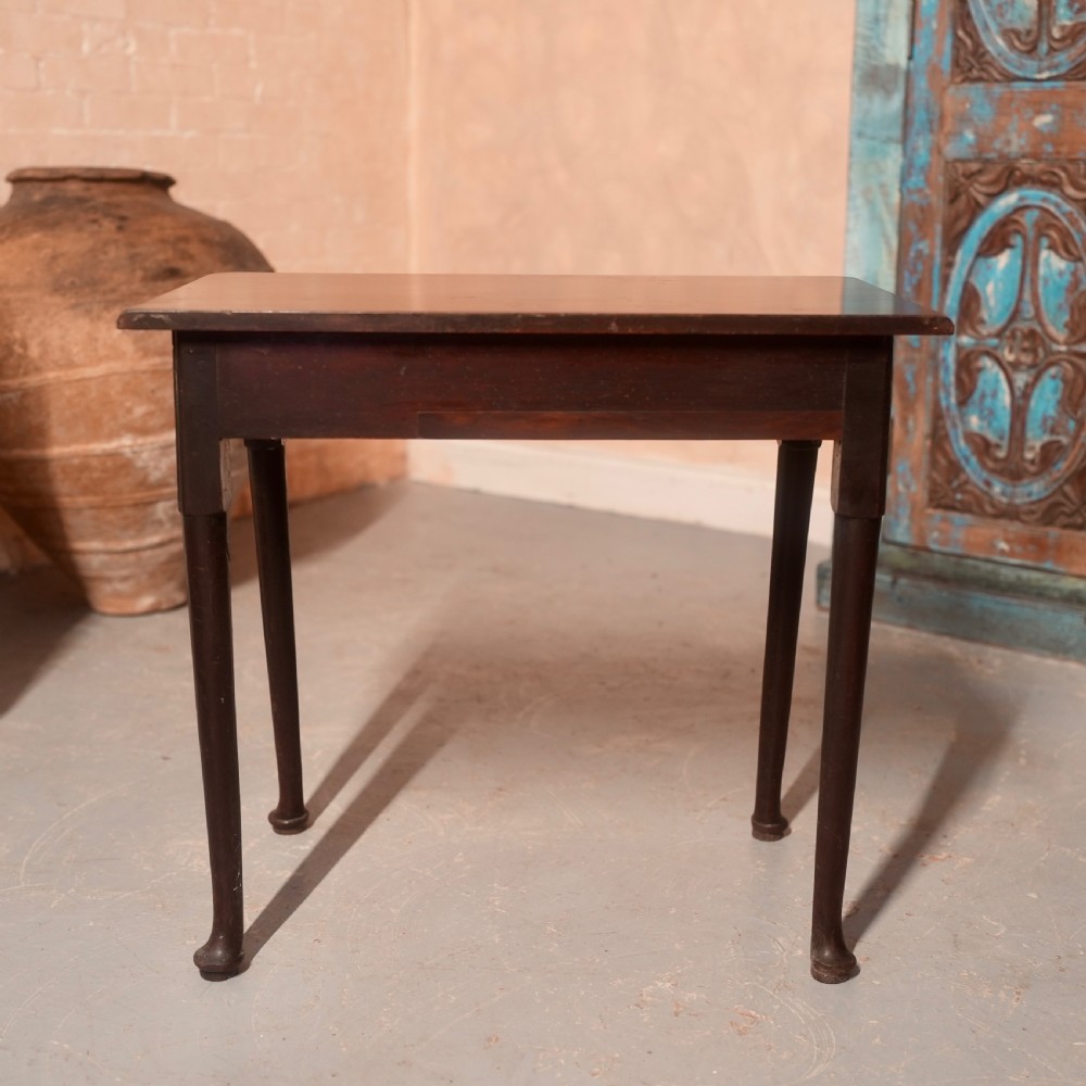 An 18th-century dark mahogany writing table featuring a single drawer with a brass handle plate and slender legs. View IX