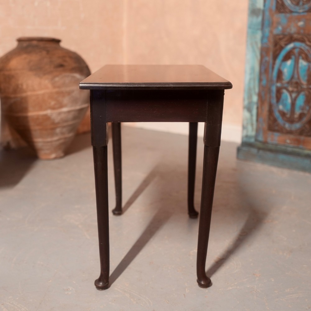 An 18th-century dark mahogany writing table featuring a single drawer with a brass handle plate and slender legs. View X