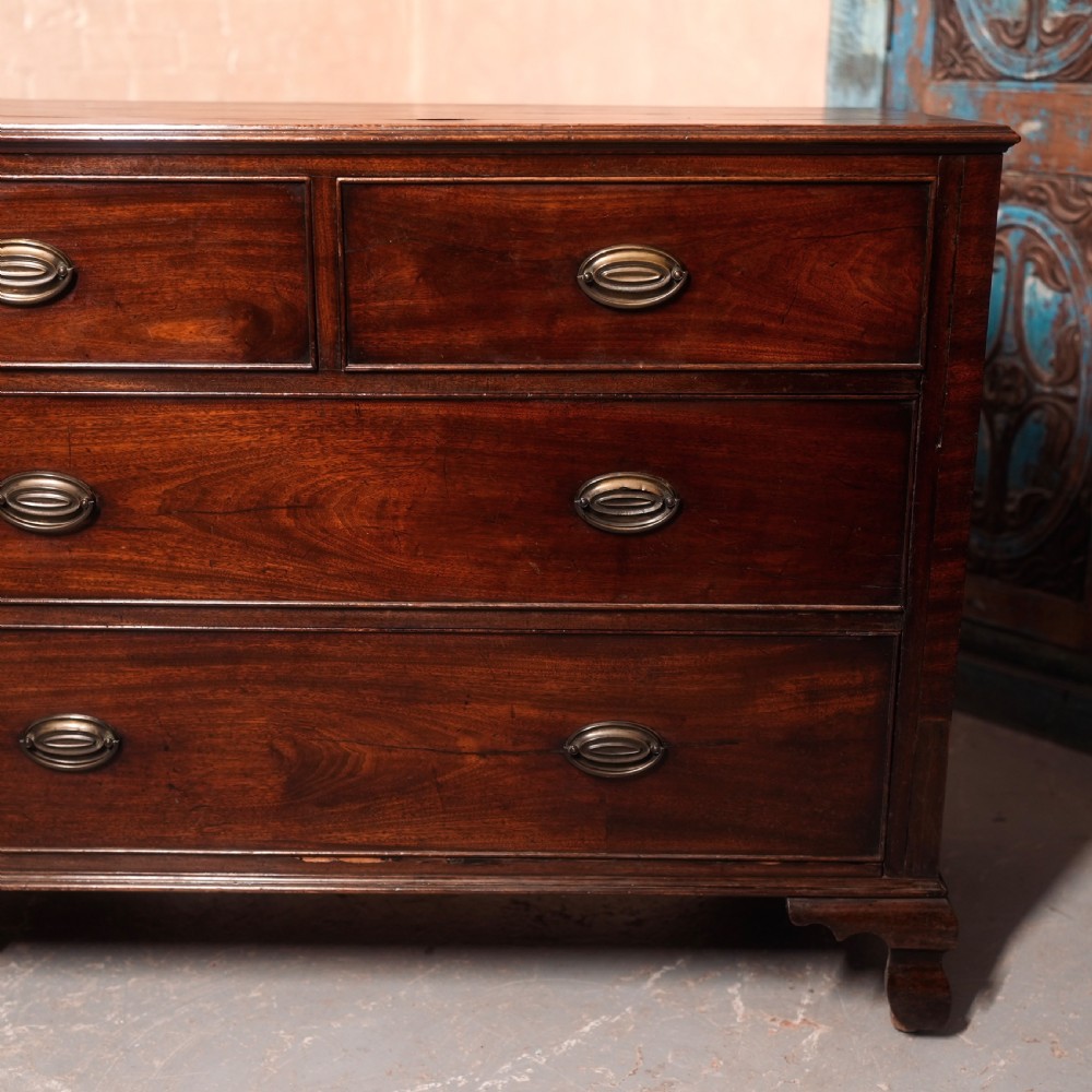An 18th-century Georgian mahogany chest of drawers featuring two short over two long drawers, oval brass handles, and bracket feet. View III