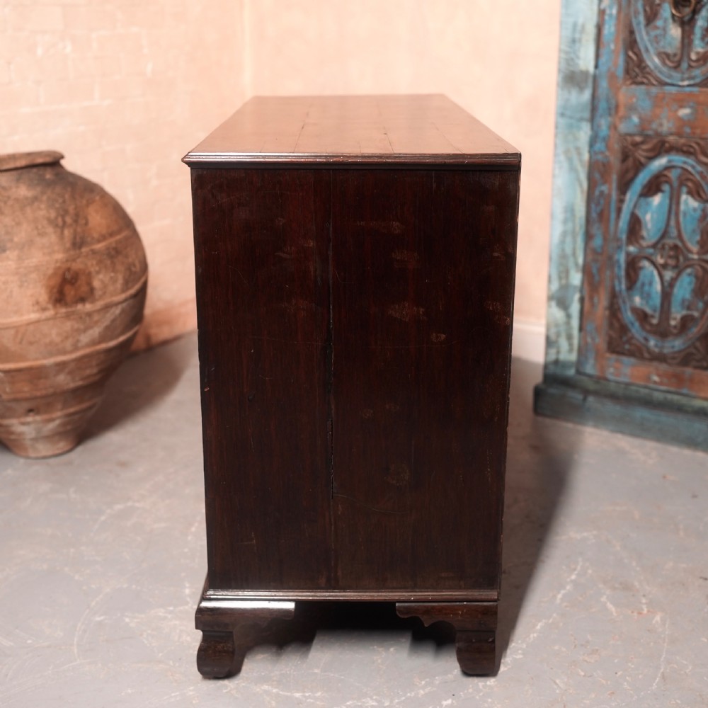 An 18th-century Georgian mahogany chest of drawers featuring two short over two long drawers, oval brass handles, and bracket feet. View XI