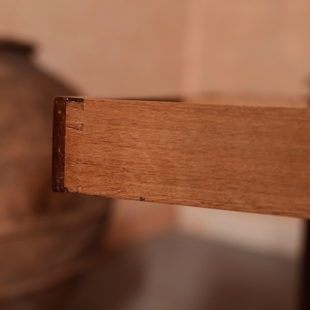 A Georgian mahogany writing table featuring a low gallery rim, two frieze drawers with turned wooden knobs, and slender turned legs. View X