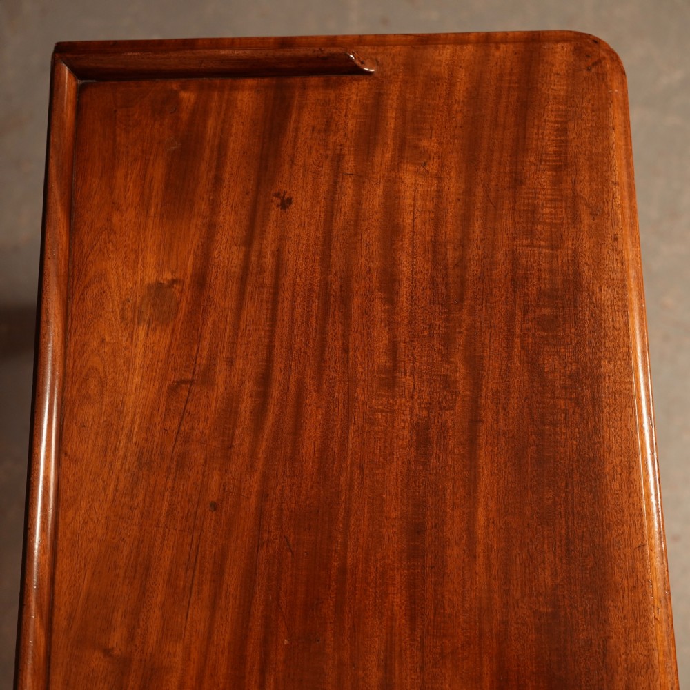 A William IV mahogany writing table featuring a raised gallery top, two frieze drawers with wooden knob handles, and reeded turned legs with brass castors. View VII