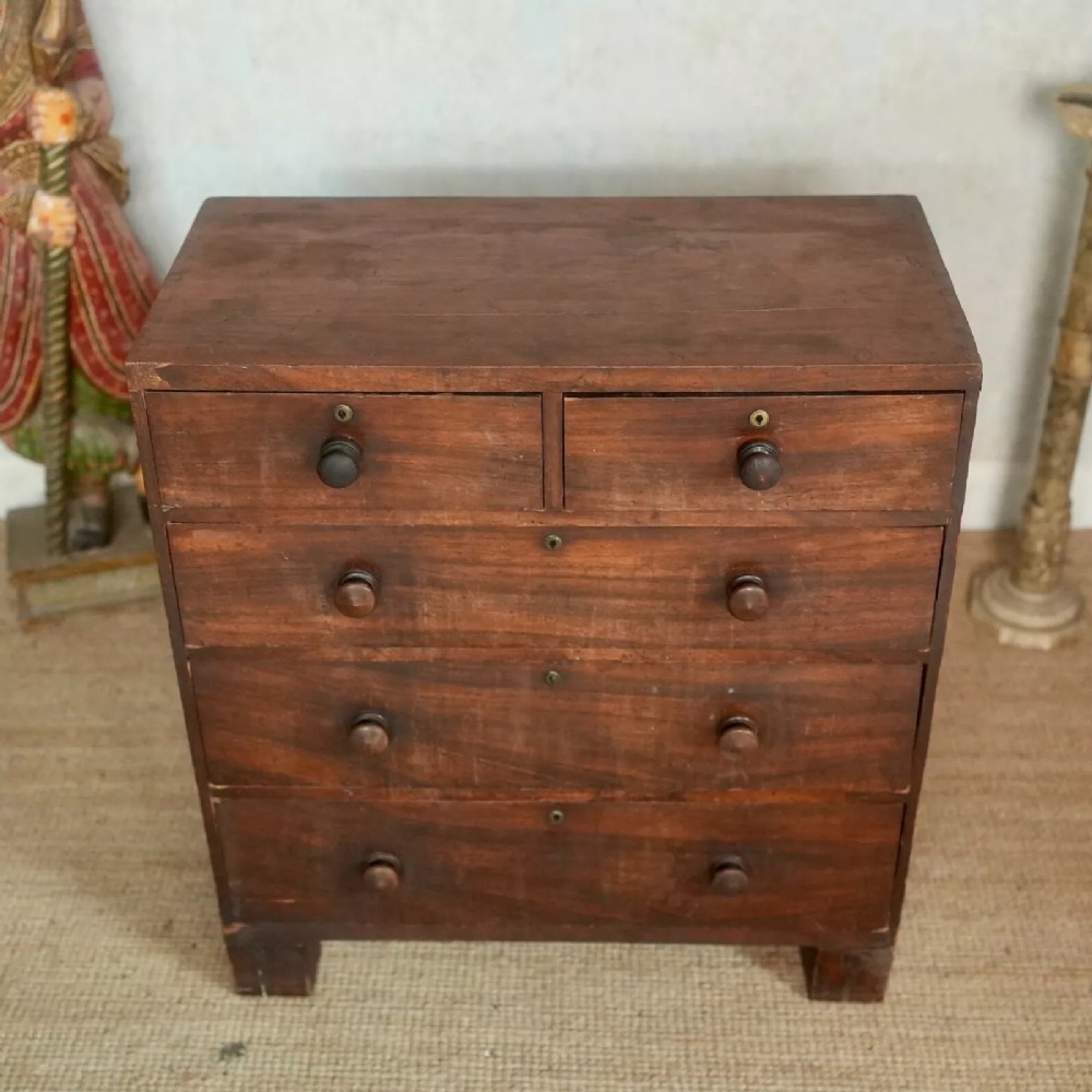 An 18th-century Georgian dark wood chest of drawers featuring a two-over-three drawer layout with turned wooden handles.