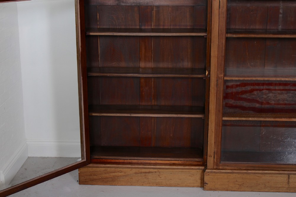 A low, wide Georgian mahogany breakfront bookcase featuring four glass doors and internal timber shelves. View VII