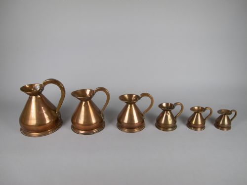 Six Graduated Vintage Copper Imperial Measuring Jugs.