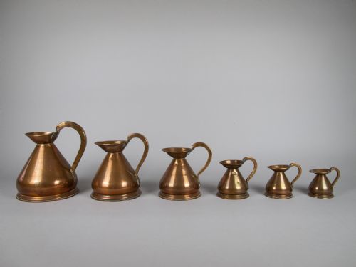 fig 1. Six Graduated Vintage Copper Imperial Measuring Jugs.