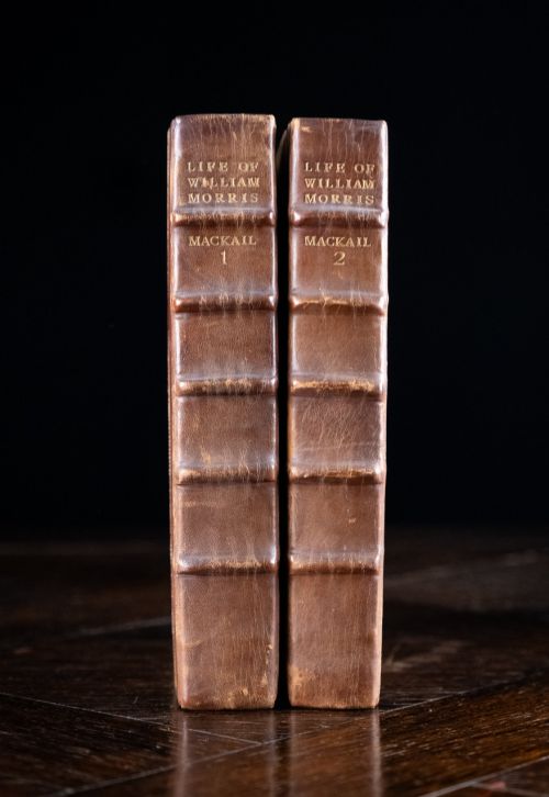fig 1. A two-volume set of 1899 first edition books titled The Life of William Morris, bound in brown leather spines with gilt lettering and cream cloth boards.