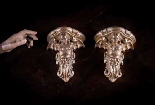 fig 1. A pair of late Victorian gilt terracotta wall brackets shaped as winged sirens with decorative acanthus scrollwork bases.
