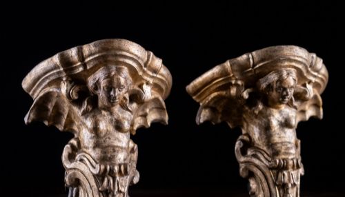 fig 4. A pair of late Victorian gilt terracotta wall brackets shaped as winged sirens with decorative acanthus scrollwork bases.