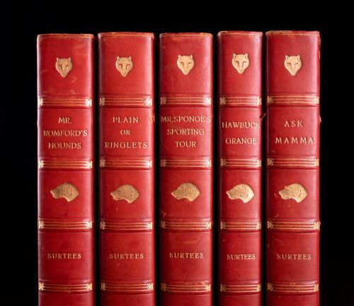 fig 1. A five-volume set of red books featuring gilt spine lettering and embossed animal motifs.