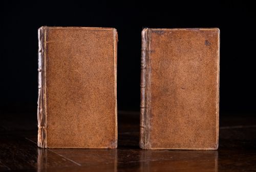 fig 2. A two-volume set of 18th-century leather-bound books featuring gilt-tooled spine details and raised bands standing vertically.