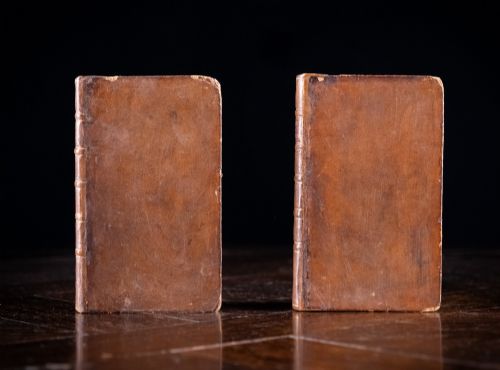 fig 2. A two-volume set of 1773 brown leather-bound books titled The Man of the World with gilt lettering on the spines.