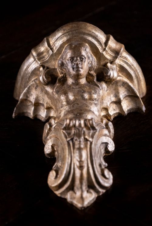 fig 2. A pair of late nineteenth-century gilt terracotta wall brackets featuring winged siren figures above acanthus scrollwork pedestals.