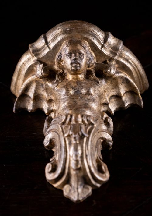 fig 3. A pair of late nineteenth-century gilt terracotta wall brackets featuring winged siren figures above acanthus scrollwork pedestals.