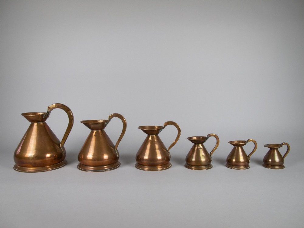 Six Graduated Vintage Copper Imperial Measuring Jugs. View II