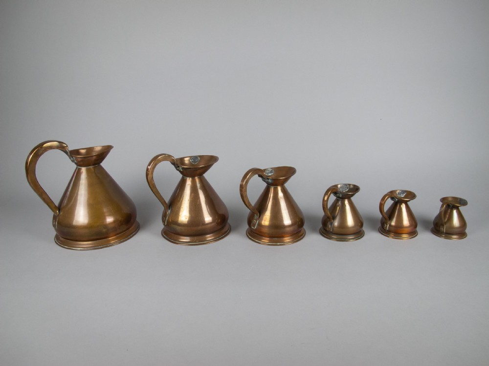 Six Graduated Vintage Copper Imperial Measuring Jugs. View IV