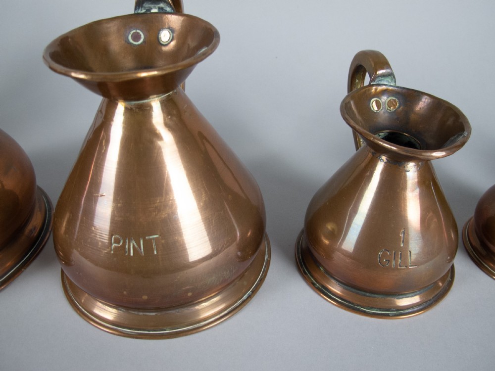 Six Graduated Vintage Copper Imperial Measuring Jugs. View VII