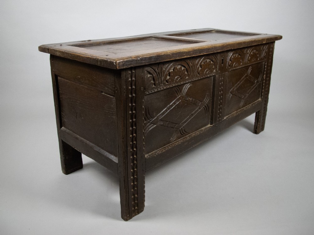 17th Century Carved Oak Coffer With Raised Legs & Original Iron Loop Hinges.
