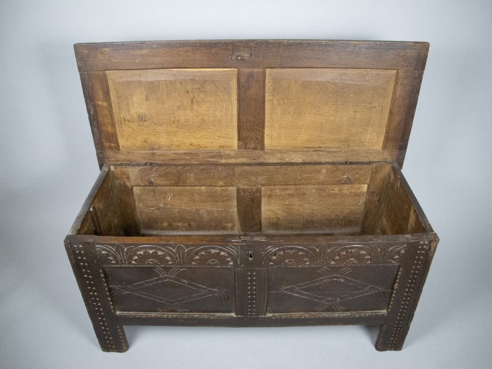 17th Century Carved Oak Coffer With Raised Legs & Original Iron Loop Hinges. View XVI