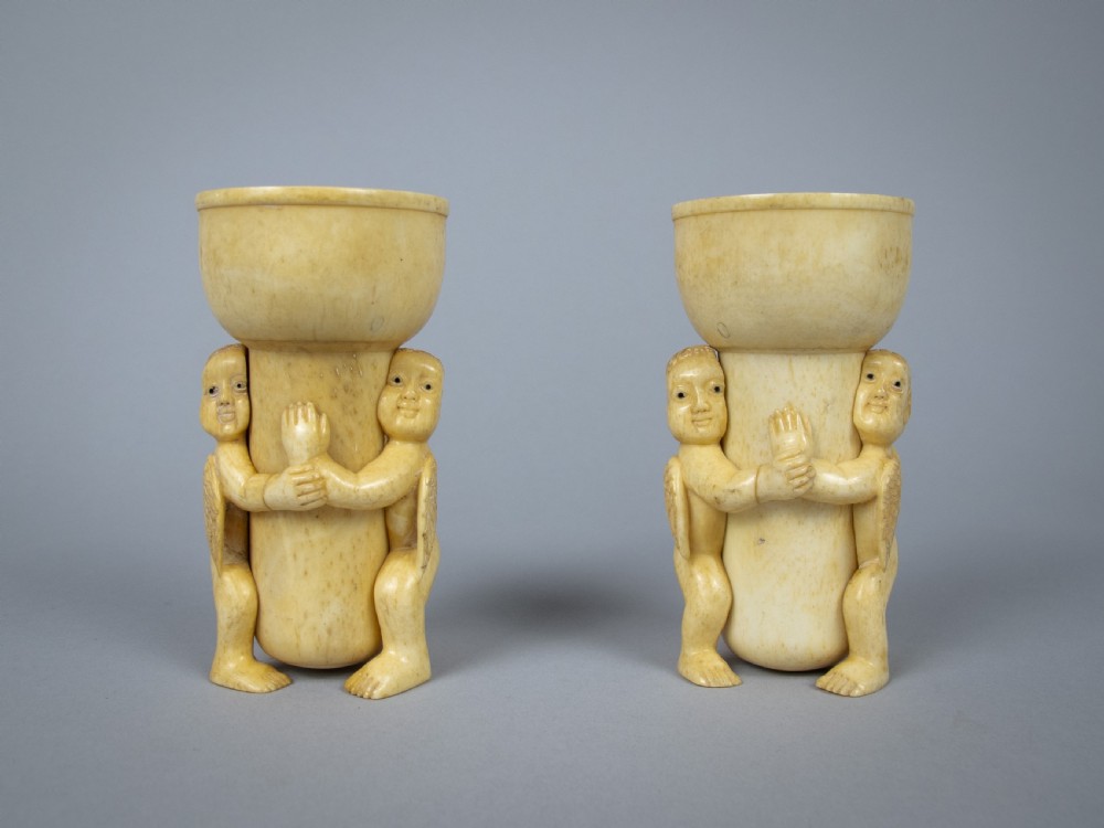 Unusual Pair of 19th Century Carved Bone Cherub Candle Holders. View II